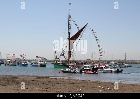 West Mersea, Großbritannien. 13. August 2022. Die West Mersea Regatta findet auf Mersea Island statt. Die Regatta wird seit 1838 fast ununterbrochen durchgeführt und wird von Freiwilligen organisiert. Boote, die in der Mündung mit dem Thames Barge 'Kitty' festgemacht wurden. Kredit: Eastern Views/Alamy Live Nachrichten Stockfoto