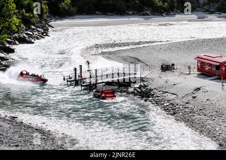 Die Besucher genießen den Nervenkitzel mit hoher Geschwindigkeit auf einem Shotover Jet-Flachbodenboot, das mit zwei 350 Mercruiser V8-Motoren angetrieben wird und eine Gesamtleistung von 700 PS erzeugt Stockfoto