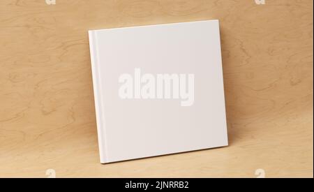 Leeres quadratisches Hardcover Buchcover-Modell, das auf einem hölzernen Hintergrund steht. 3D Rendern Stockfoto