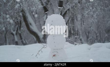 13. August 2022, Oblast Odessa, Ukraine, Osteuropa: Fröhlicher, lustiger Schneemann-akrobatin, der auf dem Kopf steht, vor dem Hintergrund eines starken Schneefalls. Schneemann steht auf seinem Kopf (Bild: © Andrey Nekrasov/ZUMA Press Wire) Stockfoto