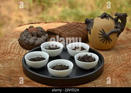 Bereiten Sie chinesischen schwarzen Tee im Teeset auf dem Holztisch zu. Trinken Sie Tee in der Natur. Stockfoto