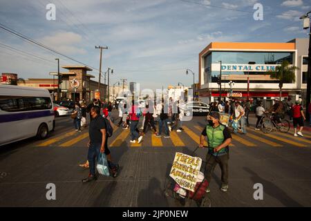 Tijuana, Baja California, Mexiko - 11. September 2021: Menschenmassen überqueren eine Straße in der Innenstadt von Tijuana. Stockfoto