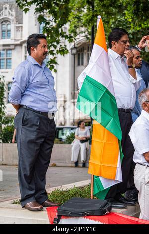 London, Großbritannien. 15. August 2022. Mitglieder der britischen indischen Gemeinschaft stehen vor der Statue von Mahatma Gandhi auf dem Parliament Square, um den 75.. Jahrestag der Unabhängigkeit Indiens am 15. August 1947 vom britischen Raj zu feiern. Kredit. Kredit: amer ghazzal/Alamy Live Nachrichten Stockfoto