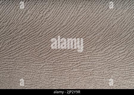 Ein beigefarbener Hintergrund mit Wandtextur Stockfoto