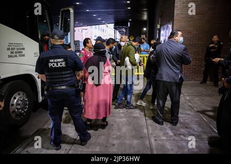 New York, USA, 15/08/2022, Asylsuchende verlassen den Bus. Ein Bus mit 52 Asylbewerbern aus Texas kam in Port Authority an. Nach Angaben von Kommissar Manuel Castro vom Büro des Bürgermeisters für Einwanderungsfragen, taten zwei von drei Bussen, die Texas verließen und anreisten, dies nicht. Der kommissar schätzt, dass etwa 120 Migranten, die nach New York City kommen sollen, unterwegs die Busse verlassen haben. Viele der Asylbewerber waren hungrig und krank, wurden Berichten zufolge gezwungen, ihre Rechte unter Druck abzuzeichnen und wurden entweder von staatlichen Strafverfolgungsbehörden oder privater Sicherheit begleitet. Stockfoto