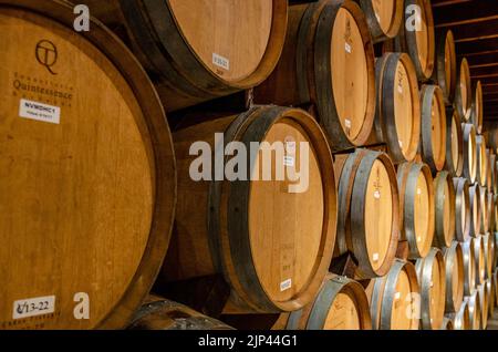 Eichenfässer gefüllt mit ausgereiftem Wein in einer Weinkellerei im Napa Valley, Kalifornien, USA Stockfoto