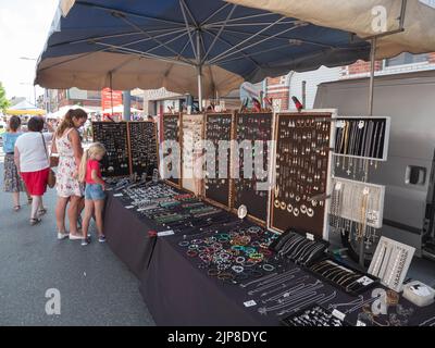 Sint Gillis Waas, Belgien, 06. August 2022, Mutter und Tochter schauen sich den Schmuck an, der in einem Marktstand ausgestellt ist Stockfoto