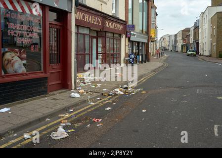 Eine schmutzige Straße in Ramsgate, gefüllt mit Tonnen von Müll, weil Möwen die Müllsäcke zerreißen Stockfoto