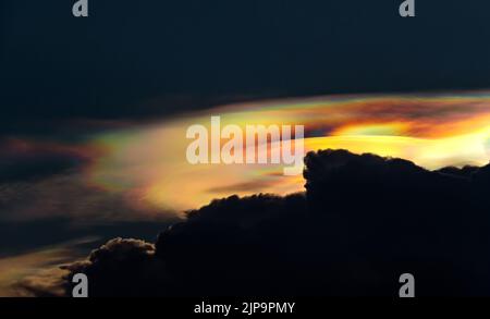 Die schillernde Wolke oder Irisierung ist ein buntes Lichtphänomen, das in Wolken auftritt. Dieses häufige Phänomen ist am häufigsten bei Altocumulus, Cirrocumu Stockfoto