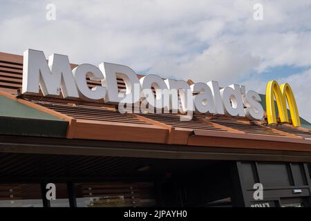 Slough, Großbritannien. 16.. August 2022. Ein McDonald's Drive Thru Restaurant in Slough. Es wird berichtet, dass der Fast-Food-Riese McDonald's eine Rekrutierungsstrategie unternimmt, um mehr als 50s Mitarbeiter wieder an den Arbeitsplatz zu bringen. Viele Restaurants haben immer noch Schwierigkeiten, Mitarbeiter zu finden, da die Menschen ihre Karriere seit der Covid-19-Pandemie verändert haben und andere Menschen jetzt lieber von zu Hause aus arbeiten. Quelle: Maureen McLean/Alamy Live News Stockfoto