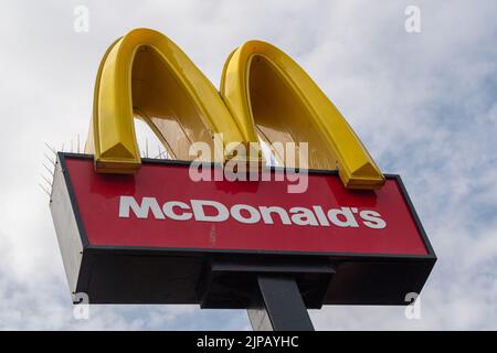 Slough, Großbritannien. 16.. August 2022. Ein McDonald's Drive Thru Restaurant in Slough. Es wird berichtet, dass der Fast-Food-Riese McDonald's eine Rekrutierungsstrategie unternimmt, um mehr als 50s Mitarbeiter wieder an den Arbeitsplatz zu bringen. Viele Restaurants haben immer noch Schwierigkeiten, Mitarbeiter zu finden, da die Menschen ihre Karriere seit der Covid-19-Pandemie verändert haben und andere Menschen jetzt lieber von zu Hause aus arbeiten. Quelle: Maureen McLean/Alamy Live News Stockfoto