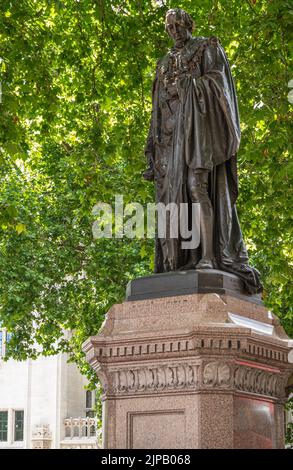 London, Großbritannien - 4. Juli 2022: Parliament Square Gardens. Bronzestatue von Benjamin Disraeli, Premierminister, mit grünem Laub. Stockfoto