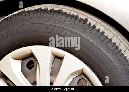 Kairo, Ägypten, August 5 2022: Nahaufnahme eines schwarzen Autoradreifens auf einem Parkplatz auf dem Asphalt mit einem guten Stickstoffluftdruck, Brückenstein verwendet tyr Stockfoto