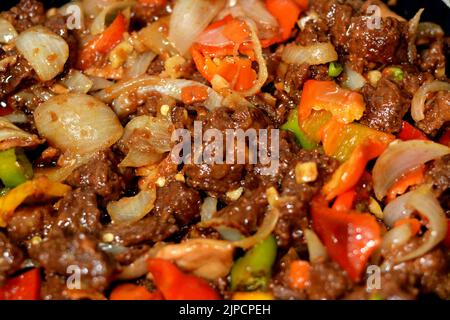 Chinesische Küche von gegrilltem Rindfleisch rote Fleischstücke und Würfel mit Öl, Pilz, Gemüse, Erbsen, Karotten, Bunte Paprika, Glocke, Chili, On Stockfoto