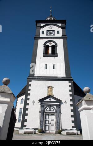 Eine achteckige, weiß getünchte Steinkirche wurde 1784 in Røros, einer Bergbaustadt mit historischen Holzgebäuden in Mittelnorwegen, erbaut. Stockfoto