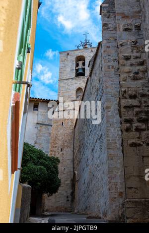 Glockenturm der Stiftskirche Saint-Paul, von einer schmalen Straße in der Altstadt von Hyères aus gesehen Stockfoto