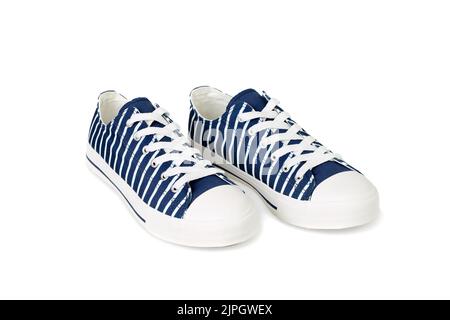 Paar neue, trendige marineblaue Sneakers mit weißen Streifen, isoliert auf weißem Hintergrund. Stockfoto
