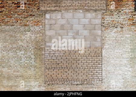 Eine alte Ziegelwand aus einer großen Anzahl von verschiedenen Ziegeltypen, Teil eines alten Gebäudes, das viele Male repariert und erneuert wurde Stockfoto