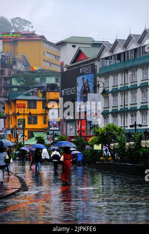 Gangtok, Indien - 17. Juni 2022: Menschen, die während der Regenzeit in der MG Marg Straße spazieren. Stockfoto