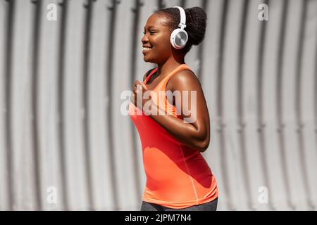 Glückliche afroamerikanische Frau, die draußen läuft Stockfoto