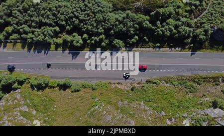 Luftaufnahme der A830 an der Westküste der schottischen Highlands mit Motorradfahrern und Auto sowie einem Auto, das in einem Zwischenstopp geparkt ist - Foto: Geopix Stockfoto