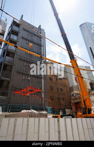 Tokio, Japan. 19. August 2022. Ein Kran trägt eine Kapsel während des Abrisses am Nakagin Capsule Tower in Ginza am 19. August 2022 in Tokio, Japan. Der Rückbau von 140 Einzelkapseln des futuristischen Gebäudes (Mischnutzung Wohn- und Büroturm) wird im Rahmen der Abbrucharbeiten bis Ende dieses Jahres fortgesetzt. Quelle: Rodrigo Reyes Marin/AFLO/Alamy Live News Stockfoto