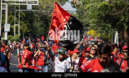 The group of football club fans at the Atlas championship parade walking in the street with a big flag Stock Photo