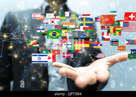 Die Hand eines Mannes mit illustrierten internationalen Flaggen-Ikonen Stockfoto