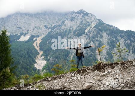 Foto von Weibchen, die vor den Bergen und grünen Wäldern stehen. deutschland, Alpen Juli 17 2022. Stockfoto