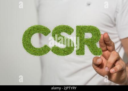 Ein Finger, der eine 3D-Wiedergabe des schwebenden Textes „CSR“ berührt Stockfoto