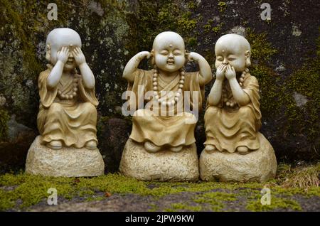 Süße buddhistische Statuen namens: "Sehen Sie kein Böses, hören Sie kein Böses, sprechen Sie kein Böses" im japanischen Tempel Daisho in Miyajima. Stockfoto