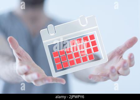 Nahaufnahme einer Person mit einem illustrativen Kalender Stockfoto
