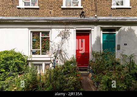 Hell gestrichene Eingangstüren auf einer Reihe von Häusern am Colville Place, Fitzrovia, London W1 Stockfoto