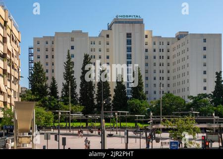 Granada, Spanien; August-2022: Hauptfassade des allgemeinen Krankenhauses des Universitätskomplexes Virgen de las Nieves in Granada (Spanien) an einem sonnigen Sommer Stockfoto