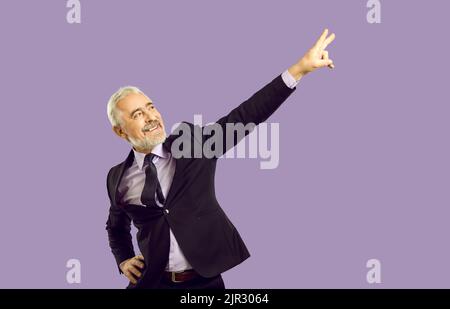 Lächelnder, gealterter Geschäftsmann, der im Studio tanzt Stockfoto