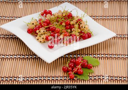 Frische rote und weiße Johannisbeeren auf einem Teller Stockfoto