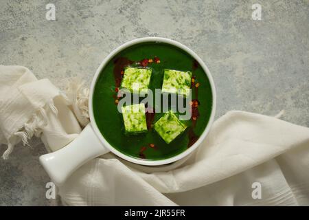 EINE SCHÜSSEL PALAK PANEER MIT EINEM TISCHTUCH IN DER NÄHE Stockfoto