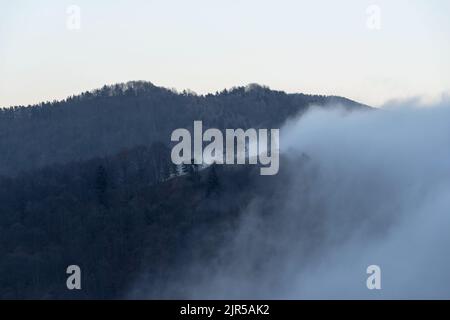 Nebel, der die Bergkette der ligurischen Alpen enthüllt, Provinz Imperia, Italien Stockfoto