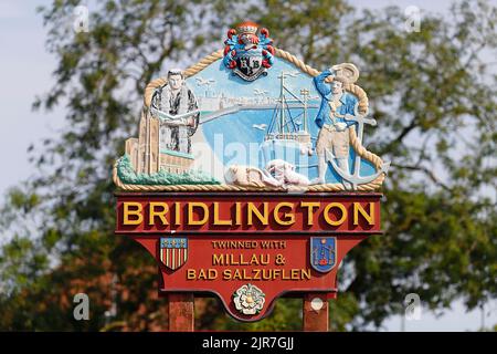 Ein Willkommensschild, wenn Sie die Küstenstadt Bridlington an der Yorkshire Coast betreten. Das Schild zeigt das Symbol der Yorkshire Rose und das Wappen von Bridlington Stockfoto