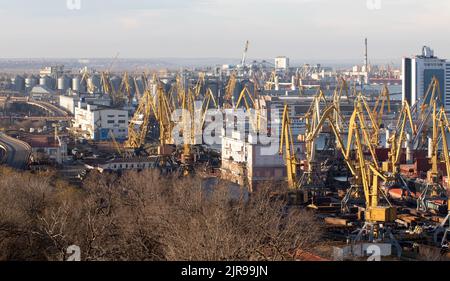 ODESSA, UKRAINE-27. NOVEMBER 2021: Odessa Handelshafen in Friedenszeiten 4 Monate vor Kriegsbeginn mit Russland. Schiffskräne, Lagerhäuser, Tanker Stockfoto