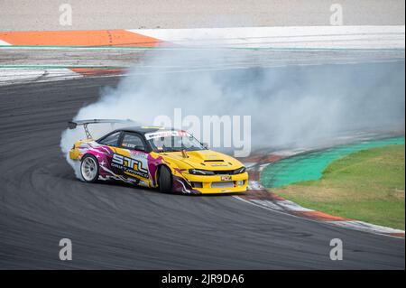 Ein japanisches gelbes Nissan Silvia S14 Kouki-Auto, das auf einer Rennstrecke rutschte Stockfoto