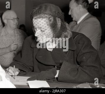 Schauspielerin Greta Garbo füllt Papiere für die Staatsbürgerschaft der Vereinigten Staaten 1950 aus. Stockfoto