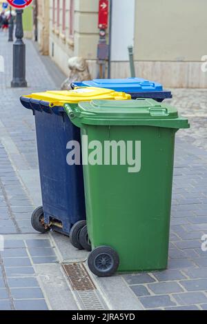 Sortieren von Abfällen drei farbcodierte Wheelie-Behälter in der Straße Stockfoto