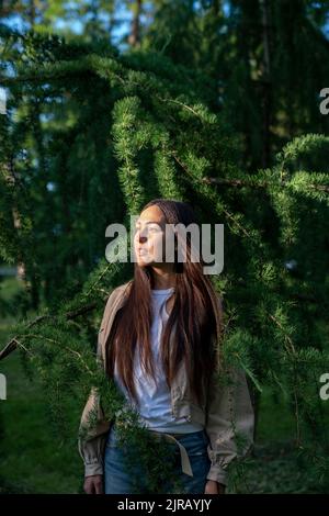 Kontemplative Frau, die im Park steht Stockfoto