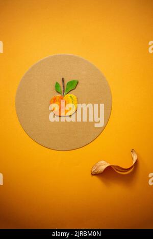 Stillleben mit einem Apfel und einem trockenen Blatt auf Pappe gemalt Stockfoto