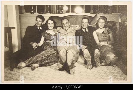 [People seated on the floor at a Party], um 1940, Wellington, von Leicagraph Studio (Wellington). Stockfoto