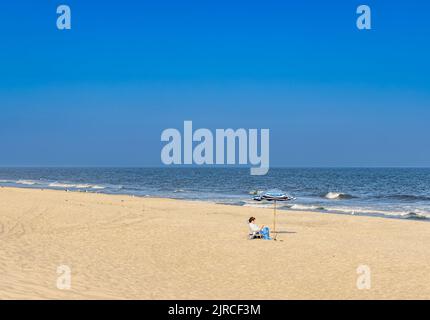 Allein sitzende Frau am Mecox Beach Stockfoto