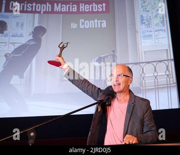 Berlin, Deutschland. 23. August 2022. Christoph Maria Herbst hält den Ernst-Lubitsch-Preis 2022 in der Hand. Herbst erhält sie für seine Rolle im Film Contra. Er wird für die beste komödianische Aufführung eines deutschsprachigen Films ausgezeichnet. Quelle: Annette Riedl/dpa/Alamy Live News Stockfoto