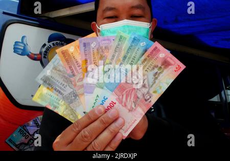 Jakarta, Jakarta, Indonesien. 23. August 2022. Am 24. August 2022 stehen die Bewohner Schlange, um die neuen 2022 Rupiah-Banknoten auf dem Senen Market, Jakarta, einzutauschen. Die Bank Indonesia (BI) hat gerade die neuen 2022-Rupiah-Banknoten in Verbindung mit dem indonesischen Unabhängigkeitstag 77. eingeführt, die Bank Indonesia und die Regierung haben 7 eingeführt, die aus IDR 100.000, IDR 50.000, IDR 20.000, IDR 10.000, IDR 5.000, Die Bank Indonesia (BI) stellt mit IDR 2.000 und IDR 1.000 sicher, dass Geld an herkömmlichen Bankautomaten verfügbar ist. Diese sieben neuen Rupiah-Denominationen sind offiziell gültig, ausgestellt und als l zirkuliert Stockfoto