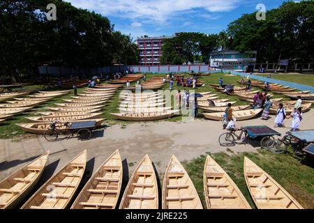 Manikganj, Dhaka, Bangladesch. 24. August 2022. Hunderte von handgefertigten Holzbooten stehen auf dem größten Bootsmarkt von Bangladesch in Manikgonj, Bangladesch, zum Verkauf. Wird von den Einheimischen während des Monsuns verwendet Wenn starke Niederschläge das Flussufer zum Platzen bringen, kostet jedes Schiff zwischen Â£30 und Â£80, abhängig von seiner Größe und der Qualität der verwendeten Materialien. Die Menschen strömten auf den Freiluftmarkt, um Boote zu kaufen, um sich auf die kommende Regenzeit vorzubereiten. Kredit: ZUMA Press, Inc./Alamy Live Nachrichten Stockfoto